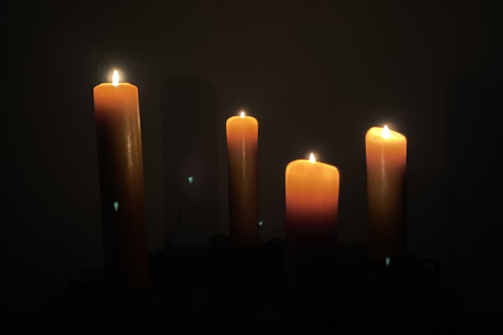 Adventskranz mit vier brennenden Kerzen